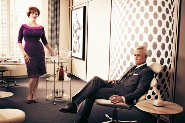 Joan Holloway (Christina Hendricks) with the bar cart in Mad Men, with Roger Sterling (John Slattery)