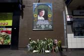 Flowers are left by a mosaic dedicated to Brazilian Jean Charles de Menezes outside Stockwell Underground Station on the tenth anniversary of his death in London on July 22 2015.