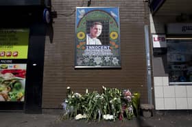 Flowers are left by a mosaic dedicated to Brazilian Jean Charles de Menezes outside Stockwell Underground Station on the tenth anniversary of his death in London on July 22 2015.