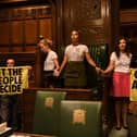 Handout photo taken with permission from the twitter feed of Extinction Rebellion of protesters who have superglued themselves around the Speaker's chair in the House of Commons chamber, as they call for a Citizen's Assembly. Picture date: Friday September 2, 2022.