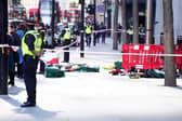 Police officers at the scene after three people have been taken to hospital following reports of stabbings at Bishopsgate in London. Picture date: Thursday October 6, 2022.
