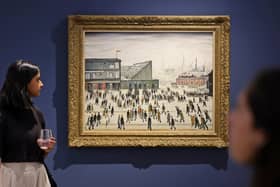 A visitor walks past "Going to the Match" by English artist LS Lowry from 1928, on display at a Christie's exhibition in Dubai on September 15, 2022