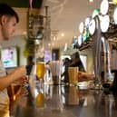 A customer buys a drink at a Wetherspoons pub in Clapham, London.