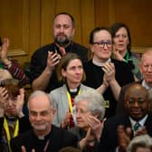 : Members of the General Synod react after blessings for same-sex couples was approved in a vote by the General Synod at The Church House.