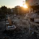 Men walk down a street amid rubble from destroyed buildings on February 20, 2023 in Hatay, Turkey