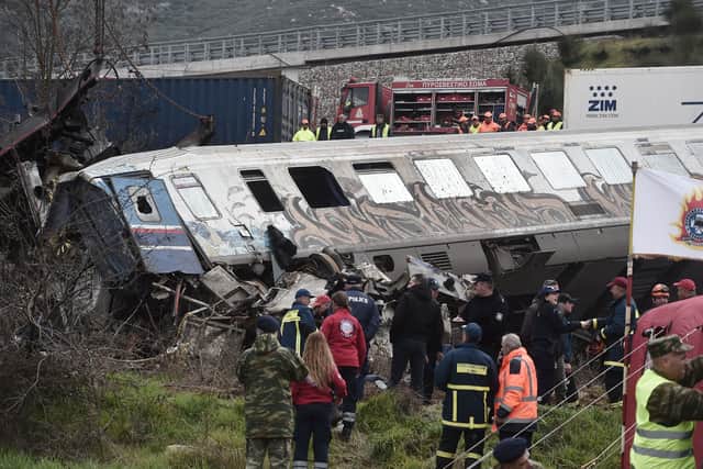 Police and emergency crews search wreckage after a train accident in the Tempi Valley near Larissa, Greece, March 1, 2023. - At least 32 people were killed and another 85 injured after a collision between two trains caused a derailment near the Greek city of Larissa late at night on February 28, 2023, authorities said. A fire services spokesman confirmed that three carriages skipped the tracks just before midnight after the trains -- one for freight and the other carrying 350 passengers - collided about halfway along the route between Athens and Thessaloniki. (Photo by Sakis MITROLIDIS / AFP) (Photo by SAKIS MITROLIDIS/AFP via Getty Images)