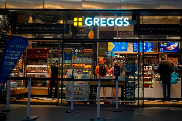 People purchase food in a branch of the bakery chain Greggs inside London Bridge station.