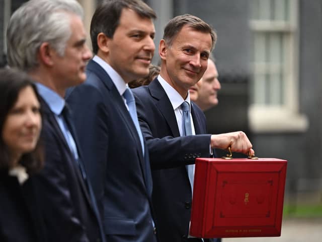 Britain’s Chancellor of the Exchequer Jeremy Hunt poses with the red Budget Box as he leaves 11 Downing Street in central London on March 15, 2023, to present the government’s annual budget to Parliament. (Photo by JUSTIN TALLIS / AFP) (Photo by JUSTIN TALLIS/AFP via Getty Images)