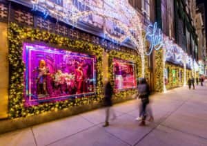 Visitors look at the Christmas window dispalys at Saks Fifth Avenue on on December 1, 2020 (Photo by Roy Rochlin/Getty Images)