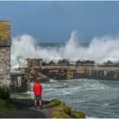 National Trust ranger Seth Jackson looks on as large waves caused by Storm Ellen strike Cornwall in 2020 (Photo by Hugh R Hastings/Getty Images)