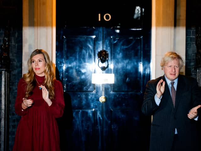 Boris Johnson (R) and his partner Carrie Symonds (L) outside 10 Downing street (Photo by Tolga Akmen / AFP) (Photo by TOLGA AKMEN/AFP via Getty Images)