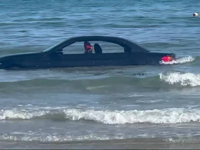 A convertable BMW was washed out to see after parking on a beach in Cornwall