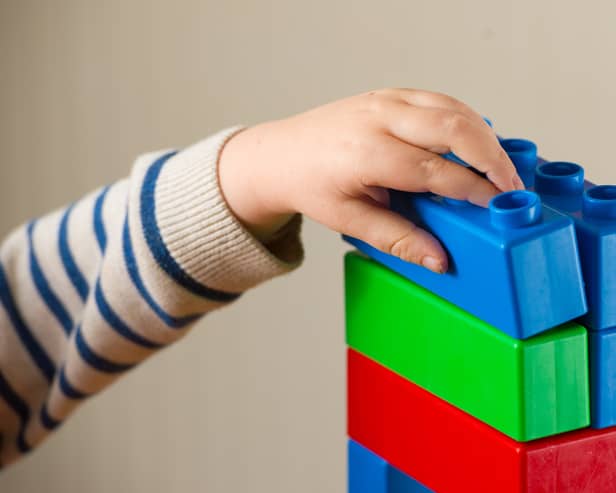 Child plays with building blocks.