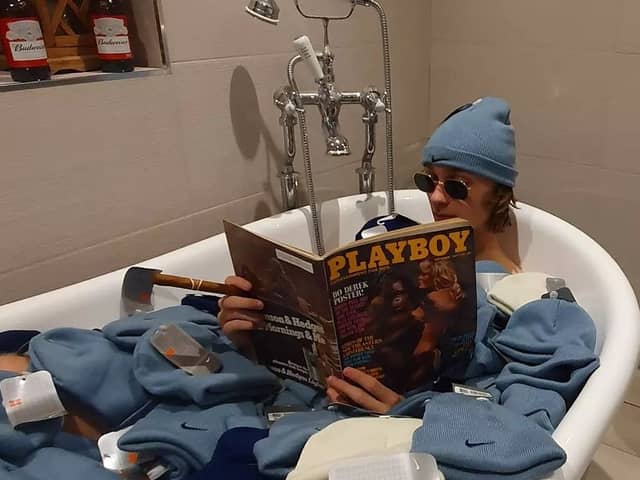 Depop entrepreneur Callum Massey poses in a bath full of deadstock nike beanies from 2002 that he purchased and resold on the site. 