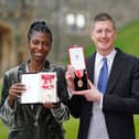 Sharon White poses with her award after she was made a Dame CBE, for public service, next to her husband Sir Robert Chote (Photo by Andrew Matthews - WPA Pool/Getty Images)