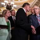 WASHINGTON, DC - JULY 26: (L-R) Sen. John Barrasso (R-WY) reaches out to help Senate Minority Leader Mitch McConnell (R-KY) after McConnell froze and stopped talking at the microphones during a news conference after a lunch meeting with Senate Republicans U.S. Capitol 26, 2023 in Washington, DC. Also pictured, L-R, Sen. Shelley Moore Capito (R-WV), Sen. Steve Daines (R-MT), and Sen. John Thune (R-SD). McConnell was escorted back to his office and later returned to the news conference and answered questions.  (Photo by Drew Angerer/Getty Images)