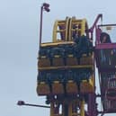 Horrified onlookers watched as rescuers scrambled to the aid of eight terrified people stuck “at the top” of a 22-metre rollercoaster.