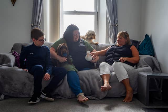 Buddy the duck chilling on the sofa with Chloe Greenwood 35, Aiden Greenwood 11, and mum Rachel Greenwood 58