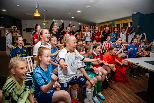 Young fans cheering on England 