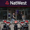 Pedestrians walk past a branch of a NatWest bank in London.