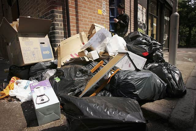 A pile of rubbish is seen in the street.