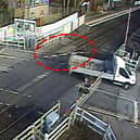 The van smashed through the level crossing barrier and dragged it along.