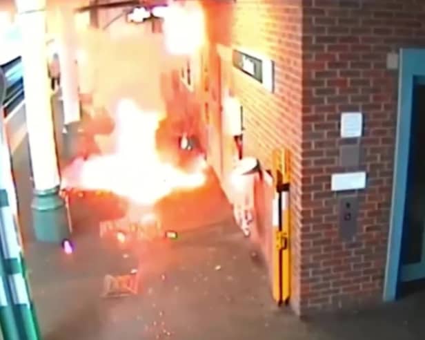 Video grab of the moment an e-bike exploded, causing a "ferocious" fire - as its owner stood waiting for a train. 