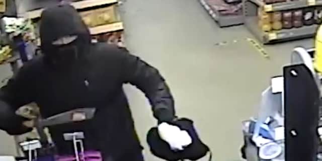 Suspect threatens shop worker with machete.