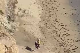 Surfer rescued from beach after spelling “Help” on the sand.