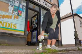 Shop worker Tracey Way, 61, pours Inch's Cider down the drain.