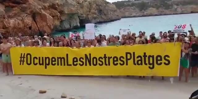Majorca anti-mass tourism protesters ‘occupy’ beach.
