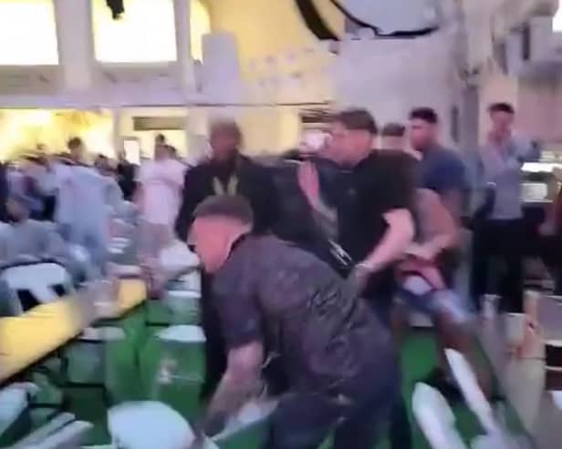 Men can be seen throwing chairs across the room at the Winter Gardens first Euros Fanzone match. 