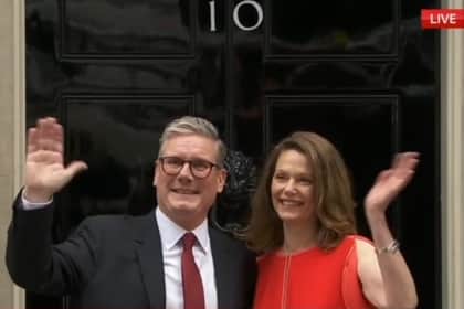 New Prime Minister Sir Keir Starmer and his wife Lady Victoria Starmer wave from 10 Downing Street.