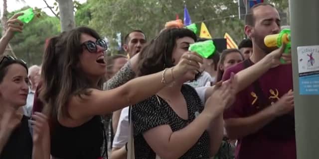 Anti-mass-tourism protesters squirt diners with water guns in Barcelona, Spain.