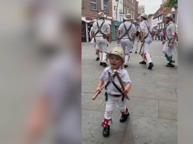 Two-year-old Toby dances along with father’s Morris dance group.
