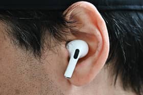 A customer wears an Apple AirPod. Photo: Patrick T. Fallon / AFP via Getty Images