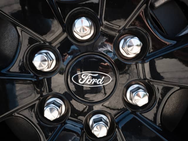 The Ford logo is shown on the wheel of a car. (Photo by Scott Olson/Getty Images)