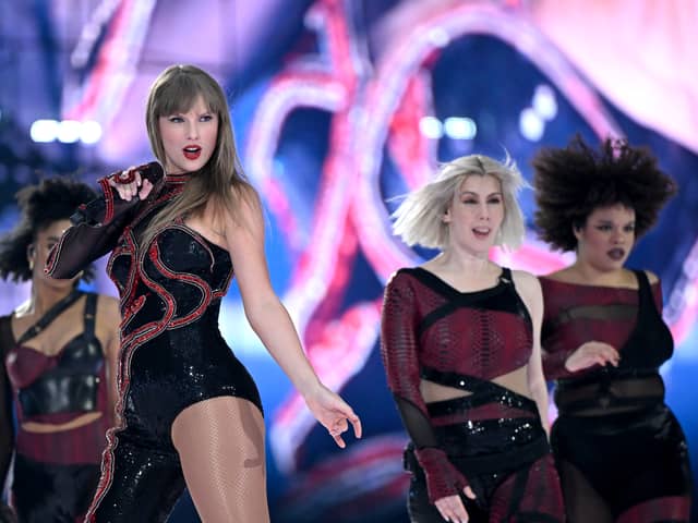 Taylor Swift onstage during the Eras Tour in her Reputation costume.