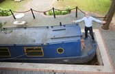 Stephen Cuddy with the mini canal lock he built to house a narrowboat turned into a swimming pool.
