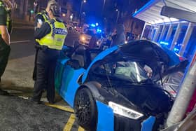 A light blue Audi R8 supercar hit a street post. 