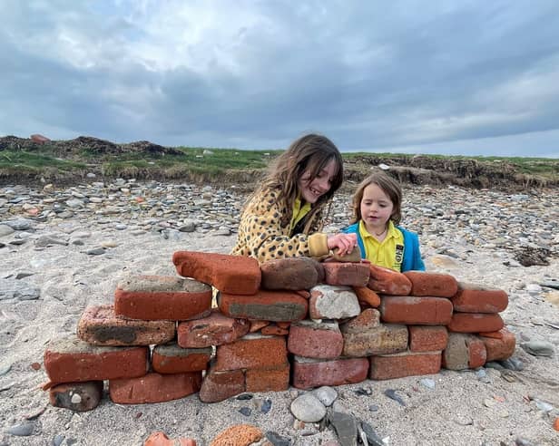 Heidi and Thea on the beach on Holy Island. Meet the family who live on an island that can only be accessed twice a day and only has five children in the local school. 