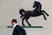 A man passes the entrance to a Lloyds Banking Group office in the City of London (Photo: JUSTIN TALLIS/AFP via Getty Images)