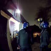 Police used a chainsaw to raid a drug house where they arrested a 13-year-old boy on suspicion of having a zombie knife. 