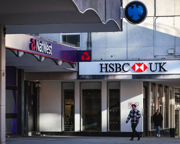 People walk pass a branches of HSBC, Natwest and Barclays banks on a pedestrianised shopping street in Bracknell town centre (Photo: ADRIAN DENNIS/AFP via Getty Images)