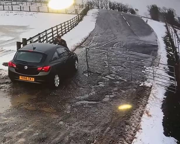 The moment Alan Lewis drove off with the staff member on the bonnet of the car. Credit: Mainsgill Farm Shop