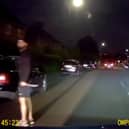 Murder victim drives away from his killer who is still grasping knife.