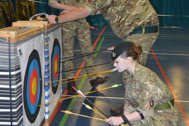 Cadets check their archery scores during the competition.