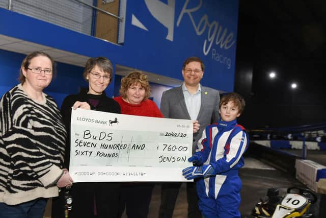 Jenson hands over a cheque of 760 to BuDs yesterday