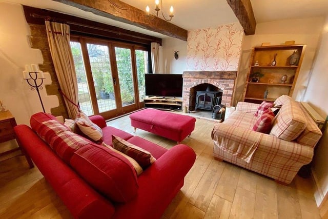 A brick fireplace houses a wood burning stove in the lounge, that has French doors out to the patio.