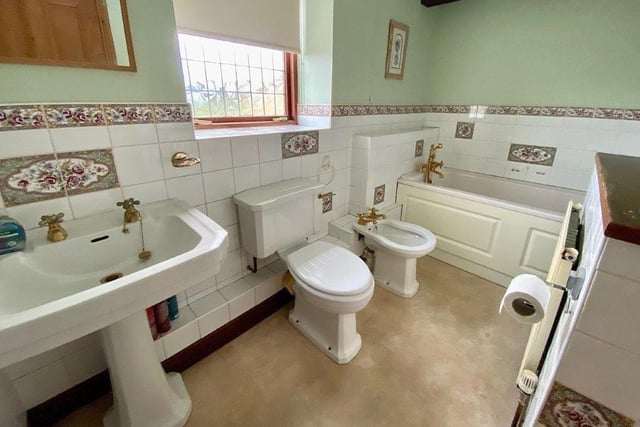 The main bathroom with white suite includes a bidet.